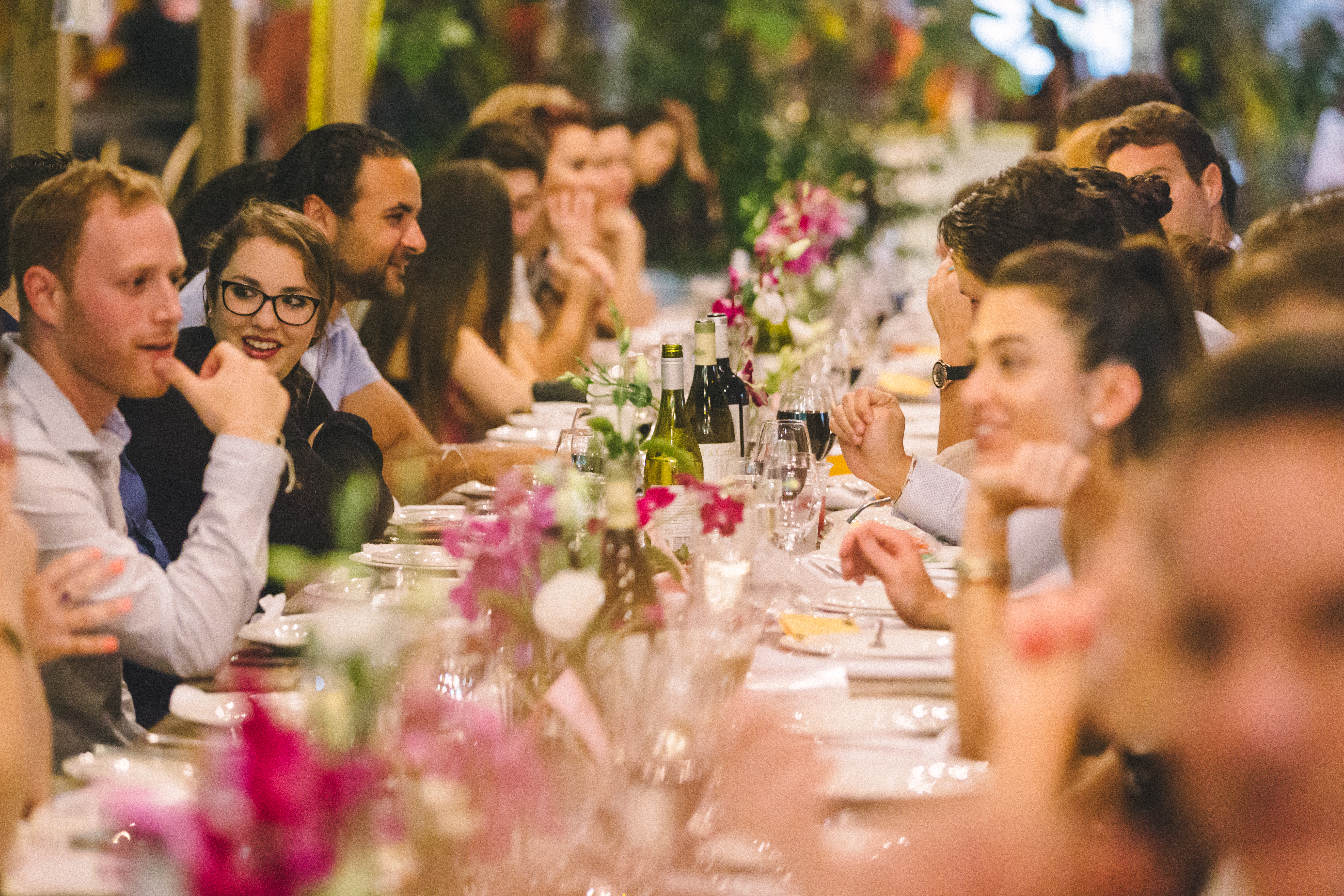 Guests sitting at a communal table eating together