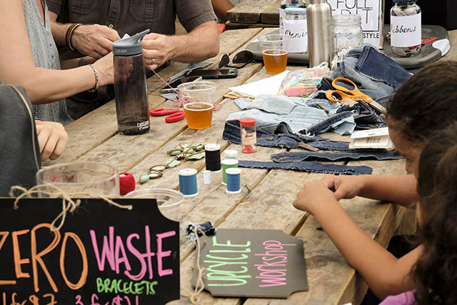 Kids make zero-waste bracelets during an Earth Day celebration at The Wynwood Yard.